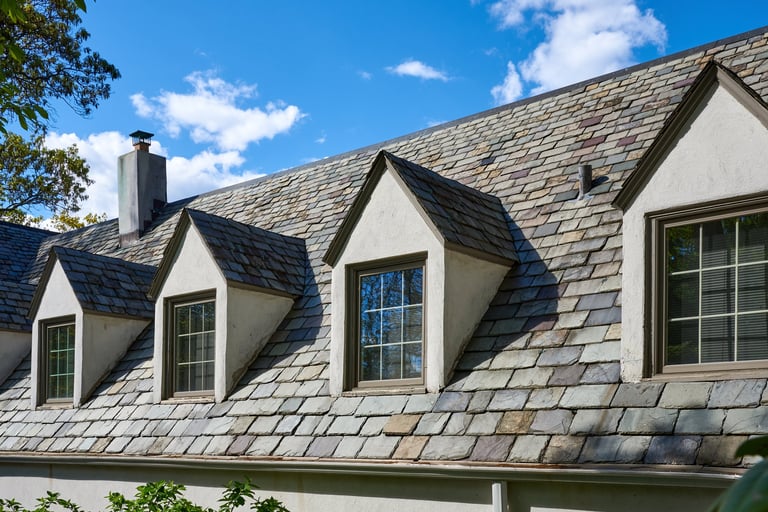 Slate roof with dormers on historic building