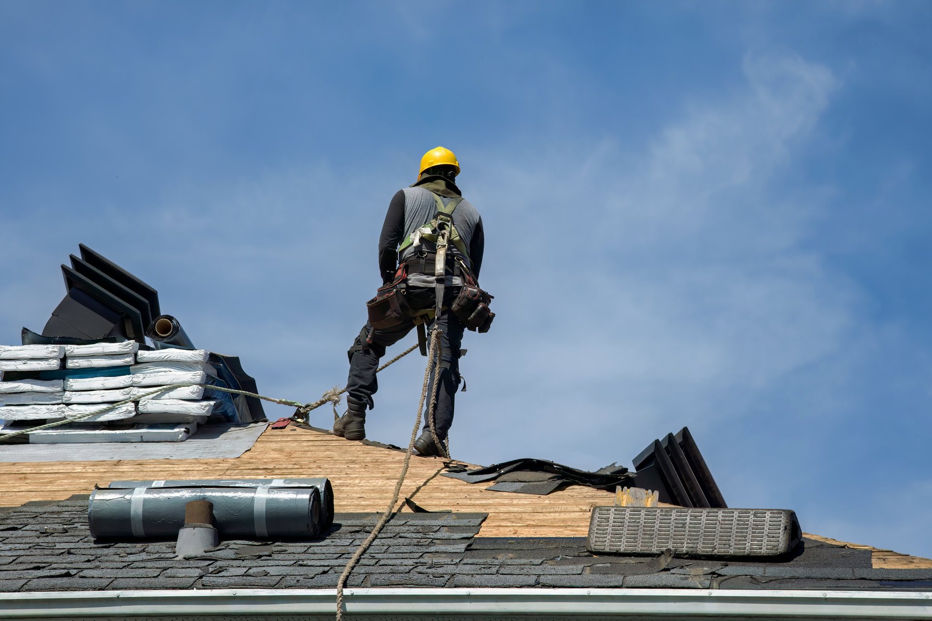 Construction worker installing roof materials